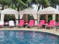 Royal Hawaiian Hotel, Honolulu, Hawaii -4/27/2018 - Lounge chairs and umbrellas by the pool at the Royal Hawaiian Hotel in Hawaii Royalty Free Stock Photo