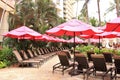 Royal Hawaiian Hotel, Honolulu, Hawaii -4/27/2018 - Lounge chairs and umbrellas by the pool at the Royal Hawaiian Hotel in Hawaii Royalty Free Stock Photo