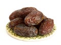 Royal large dates Medjool on a clay plate on a white background Royalty Free Stock Photo