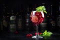 Royal lemonade alcoholic cocktail drink with tequila, dry gin, white rum, vodka, liquor, lime, raspberries and ice in wine glass. Royalty Free Stock Photo