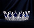 Royal luxury gold crown with sapphire on black background