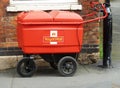 Royal Mail trolley tied to a post in the street