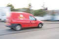 Royal Mail van blurred and in motion.