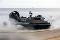 Royal Marines Military Hovercraft coming ashore on a sandy beach during armed forces day