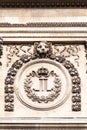 Royal monogram of Louis XVIII, King of France, on the facade of the Louvre Palace in Paris, France