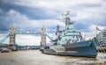 Royal Navy Cruiser HMS Belfast Moored in Thames with Tower Bridge in Background, London, England Royalty Free Stock Photo