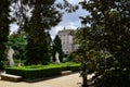 The Royal Palace of Madrid seen through several of its trees.