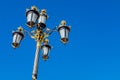 The Royal Palace, Madrid, Spain. Luxury goldish street lighting system on blue sky