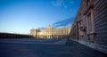 Royal palace with tourists illuminated on spring night in Madrid