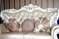Royal sofa with pillows in beige luxurious interior
