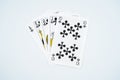 Royal straight flush playing cards poker hand in clubs isolated on white background Royalty Free Stock Photo