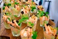 Royal tiger prawn snacks. Shrimps, greens, olives dressing appetizer in glasses shots. Fresh seafood catering service Royalty Free Stock Photo