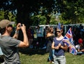 Royal Wedding atmosphere in Windsor woman taking photo flag