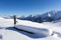 Frozen cow trough covered with deep snow on the high Alps