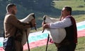 Rhodope bagpipers playing tunes on a Rozhen folklore festival in Bulgaria Royalty Free Stock Photo