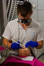 Rozhnyativ, Ukraine, September 15, 2020: patient in the dentist`s office, dental filling, cleaning teeth from tartar, woodpacker