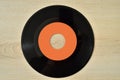 45 rpm old vinyl record on the wooden table Royalty Free Stock Photo