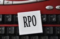 RPO - abbreviation on a white sheet against the background of a computer keyboard
