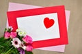 Red heart on blank greeting card with pink flowers bouquet, copy space for love message Royalty Free Stock Photo