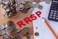 `RRSP` Registered Retirement Savings Plan signs with coins in the background Royalty Free Stock Photo