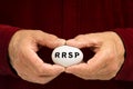 RRSP written on an egg held by man Royalty Free Stock Photo