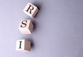 RSI word on wooden block with pen and calculator on blue background