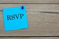 RSVP - acronym written on a blue sheet pinned to a wooden board