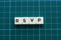 RSVP word made of square letter word on green background.