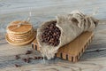 ruast arabic coffee beans in burlap with stack of dutch waffles on wooden table Royalty Free Stock Photo