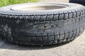 Rubbed wheel of lorry. worn wheel with hole in tire, worn rubber tread to cord