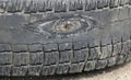 Rubbed wheel of lorry. worn wheel with hole in tire, worn rubber tread to cord