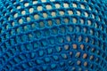 Rubber ball, covered with blue woven mesh. Abstract texture of multi-colored woven fabrics. Creative vintage background Royalty Free Stock Photo