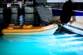 A rubber boat is moored to a yacht in the seaport. Night Scene Royalty Free Stock Photo