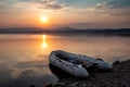 Rubber boat on the shore of the picturesque coast against the backdrop of sunset Royalty Free Stock Photo