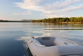 The rubber boat is tied in a picturesque bay buried in the green of a coniferous forest. Calm and rest after sea crossing. Croatia