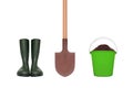 Rubber boots, shovel and plastic bucket with soil isolated Royalty Free Stock Photo