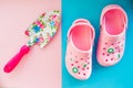 Rubber boots and garden tools on bright background.kids summer sandals and shovel with flowers pattern.Kid`s toys and Royalty Free Stock Photo