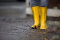 Rubber Boots are standing in a dirty puddle