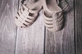 Rubber Brown baby girl sandals shoes on a wooden floor Royalty Free Stock Photo