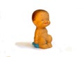 Rubber children`s old toy, little boy sitting on a pot, on a white background