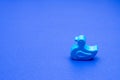 Rubber duck, little child toy on blue background, copy space