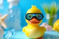 Rubber duck with mask Yellow rubber duck swimming in the water. Top view of a floating toy rubber duck on a blue background.