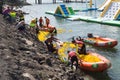 People in inflatable boats collecting thousands of rubber ducks after a race Royalty Free Stock Photo