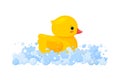 Rubber duck in soap foam with bubbles isolated in white background. Side view of yellow plastic duckling toy in suds Royalty Free Stock Photo