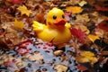 a rubber duck surrounded by autumn leaves in a puddle