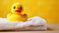 rubber duck on a white towels on a yellow background Royalty Free Stock Photo