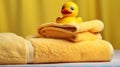 rubber duck on a white towels on a yellow background Royalty Free Stock Photo