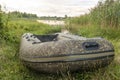 rubber Fishing boat on the shore of a beautiful lake with camouflage coloring Royalty Free Stock Photo