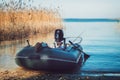 Rubber fishing boat on a tranquil lake shore. Royalty Free Stock Photo