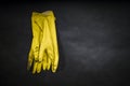 Rubber gloves used for cleaning toilet, black background